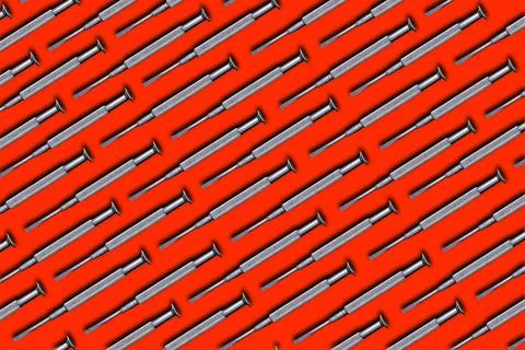 Mini screwdriver of steel. Creative pattern. Isolate on red background. 写真素材