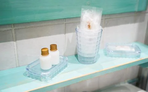 Mini set of cosmetics - shampoo, shower gel - in a hotel room while traveling Stock Photos