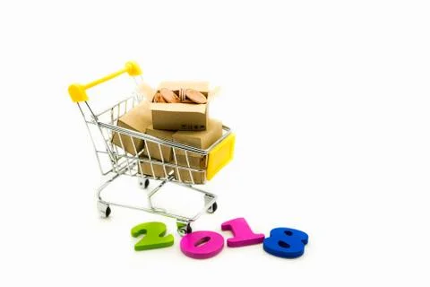 Mini  shopping cart contain stack coins in paper box Stock Photos