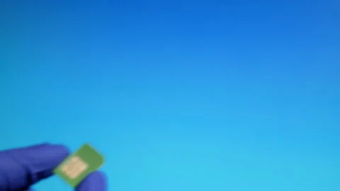 Mini sim card close-up in hands of technical workers in gloves. Selective focus Stock Footage 130813565