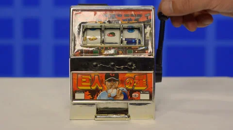 Mini slot machine started by hand Stock Footage 39739963