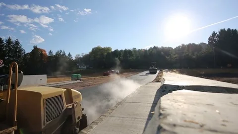 Mini Steam Roller Flattens New Road Paving across Bridge on Sunny Day 库存影片 69248059
