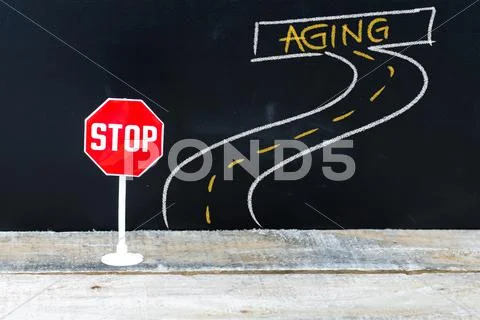 Mini STOP sign on the road to AGING Stock Photos