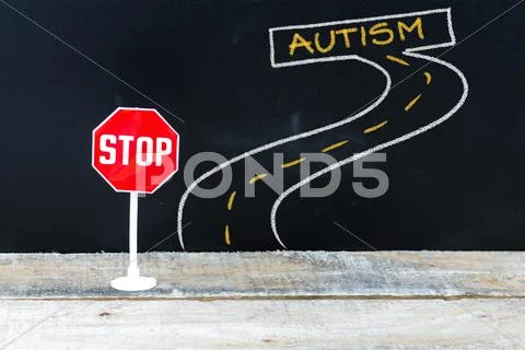 Mini STOP sign on the road to AUTISM Stock Photos