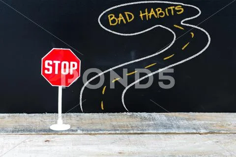 Mini STOP sign on the road to BAD HABITS Stock Photos