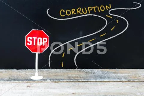 Mini STOP sign on the road to CORRUPTION Stock Photos