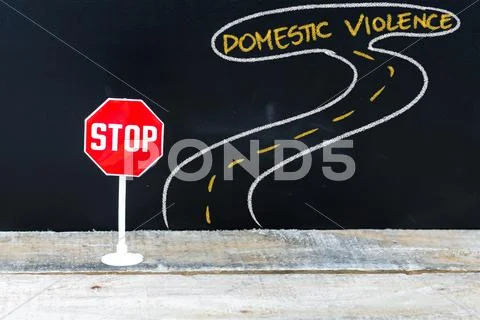 Mini STOP sign on the road to DOMESTIC VIOLENCE Stock Photos