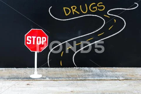 Mini STOP sign on the road to DRUGS Stock Photos