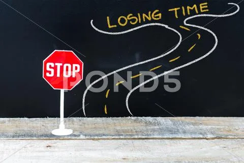 Mini STOP sign on the road to LOSING TIME Stock Photos