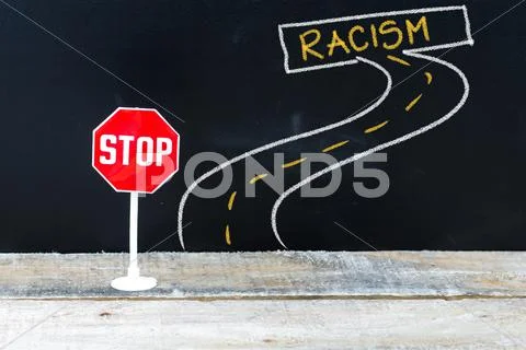Mini STOP sign on the road to RACISM Stock Photos