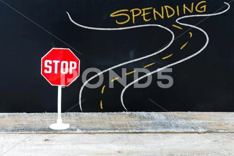 Mini STOP sign on the road to SPENDING Stock Photos