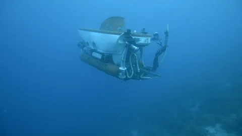 Mini Submarine floating under blue sea Stock Footage 99081486