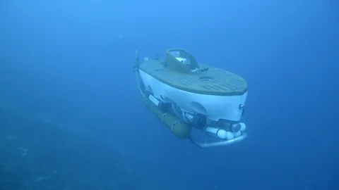 Mini Submarine floating under blue sea Stock Footage 99081594