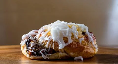 Mini sweet bread stuffed and covered with sugar icing. Selective focus. Stock Photos