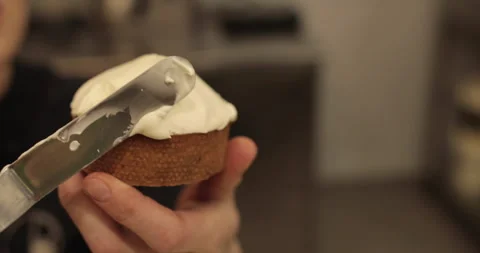 A mini-tart in the hands of a pastry chef at the time of spreading the cream. Stock Footage 251953258