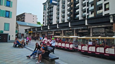 Mini train with tourists driving on the streets of Chamonix-Mont-Blanc in France Stock Footage 247251708