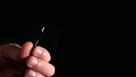 Mini USB connector in hand on a black background Stock-Footage 144840870