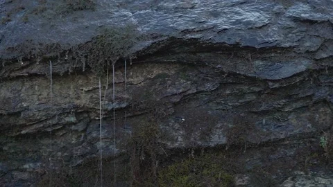 Mini waterfall in the rock Moss grows on wet stone Stock Footage 169221645