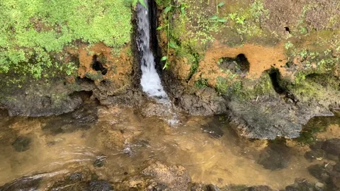 Mini waterfall from the water conduit to the river Stock Footage 295492311