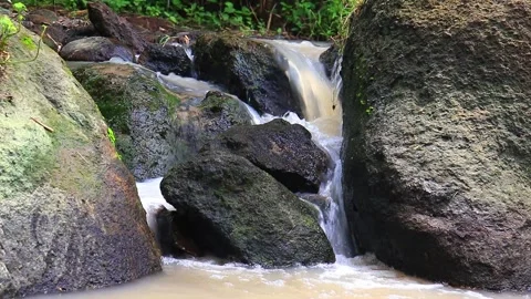 Mini waterfalls cascade on the rocks, rushing with the current Stock Footage 234749734