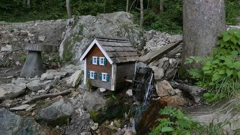Mini watermill in the forest. Stock Photos