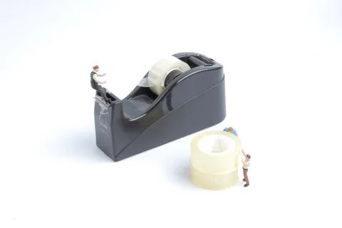 Mini of worker replace the tape for dispenser 写真素材