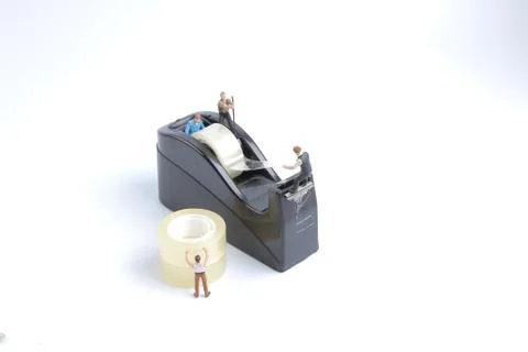 Mini of worker replace the tape for dispenser Stock Photos