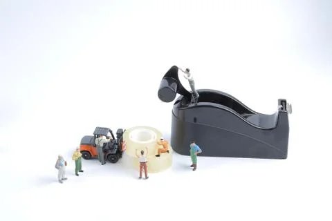 Mini of worker replace the tape for dispenser Stock Photos