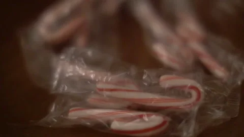 Mini Wrapped Candy Canes on table, scooped up Stock Footage 168161006