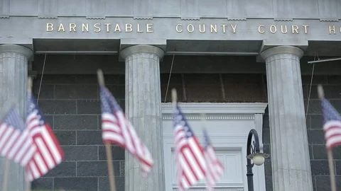 Miniature American flags with Barnstable County Courthouse in background, day. Stock Footage 111019032