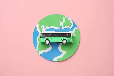 Miniature bus on a globe with world map background Stock Photos