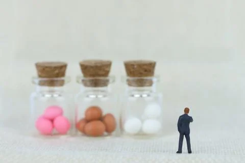 Miniature businessman is looking at easter eggs Stock-Fotos