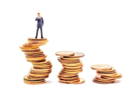 Miniature businessman on stack on white background. Concept uncertainty busin Stock Photos