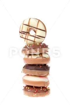 Miniature candy coated donuts decorated, in a single stack isolated on white, Stock Photos