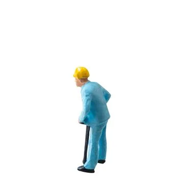 Miniature construction worker in a blue uniform isolate on white background.. Stock Photos