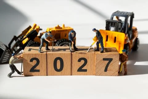 Miniature Construction Workers with Forklift and Loader Building 2027 New Y.. Stock Photos