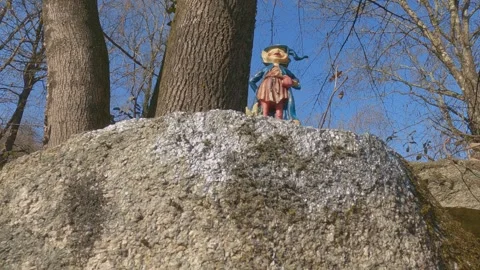 Miniature elf on stone at invorio trail of elves, low angle view Stock Footage 279873013