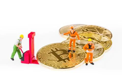 Miniature engineer and worker are mining and transferring Bitcoin activity Stock Photos