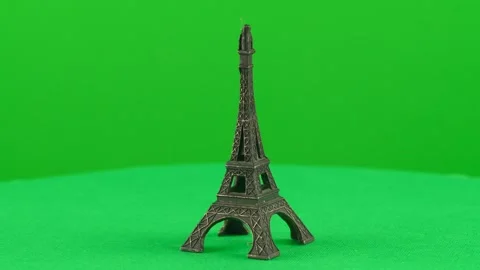 Miniature figure of eiffel tower made of metal on green background chroma Stock Footage 271554174