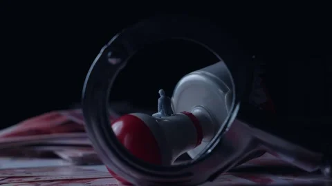 Miniature Figure on Red Stamp Handle Under Magnifying Glass Over Currency, Macro Video stock 339068420