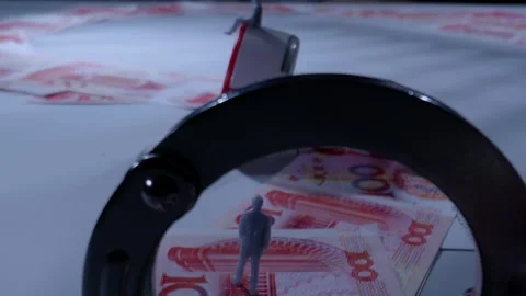 Miniature Figure Standing on Banknotes Framed by Handcuffs Macro Shot Видео 339067589