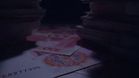 Miniature Figure Standing on Red Banknotes Amidst Money Stacks Vídeos de archivo 339068865