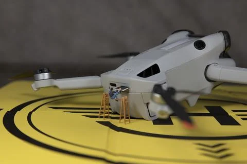 Miniature figures changing the sim card of the drone Stock Photos