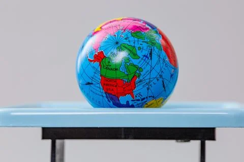 Miniature globe models on a scale Stock Photos