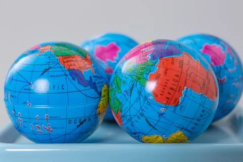Miniature globe models on a scale Stock Photos