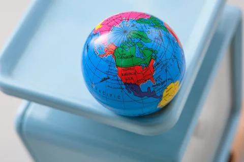 Miniature globe models on a scale Stock Photos