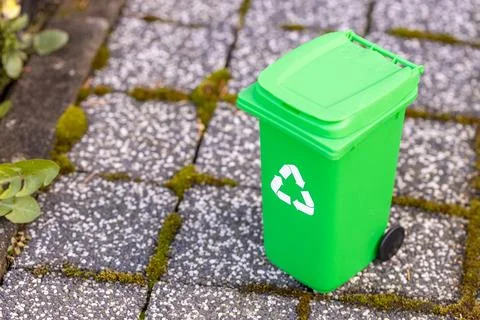 Miniature green garbage bin for biodegradable waste, Stock Photos