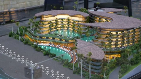 Miniature hotel resort model with pools and plants near shoreline Stock Footage 321801437