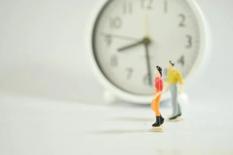 Miniature human with clock Stock Photos