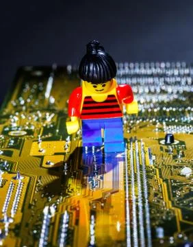 Miniature  man   posing  on a computer motherboard Stock Photos